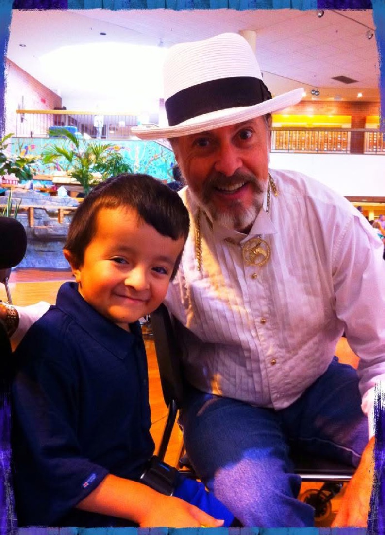 Mister Mojo smiling with a young patient at a Shriners hospital visit.